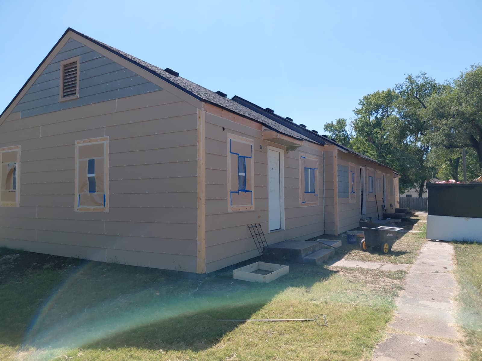 Wichita property after — new siding installed and prepped for paint