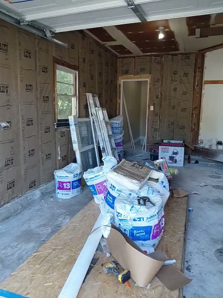 Garage converted to a room with new batt insulation installed