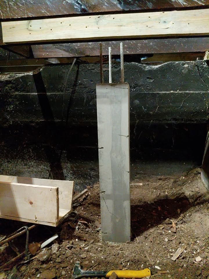 New concrete pier supporting rebuilt floor framing